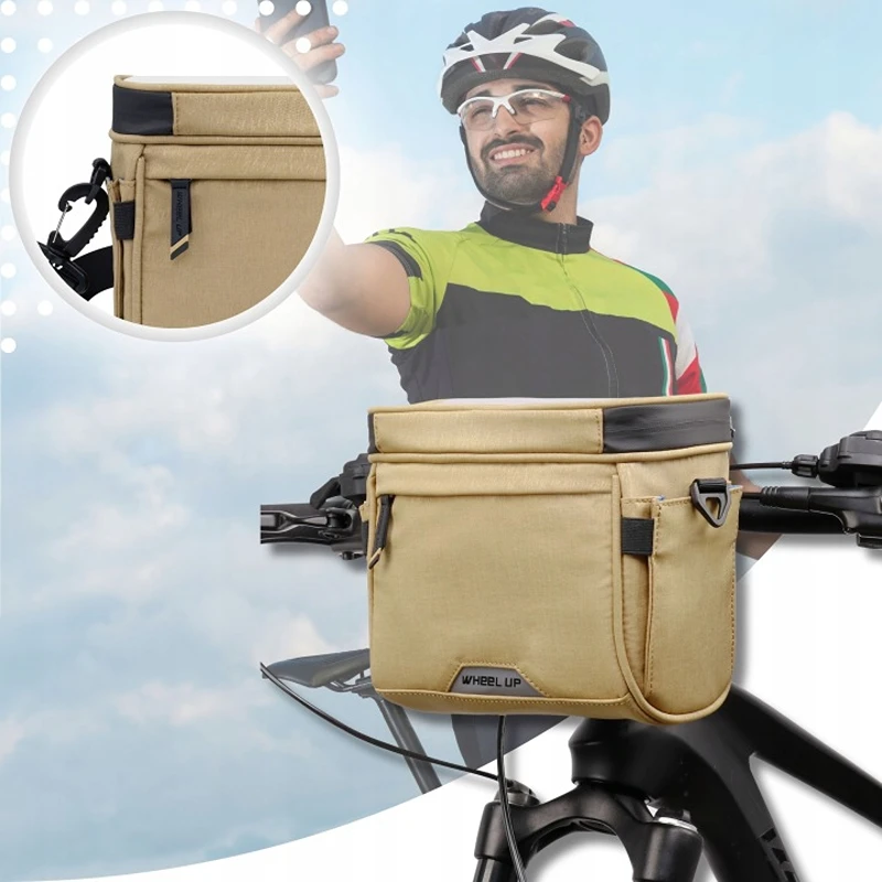 Profi cyklistická brašna na řídítka Wheel UP1468 světle hnědá s pouzdrem na telefon upevněná na horském kole během cyklistického výletu.